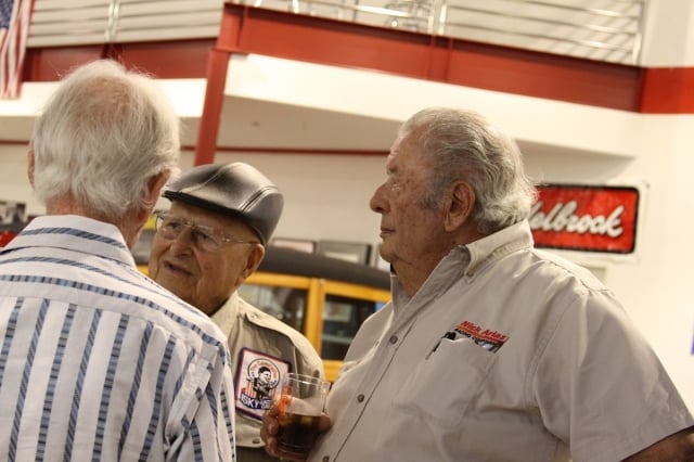 Automotive legends like Ed Pink (back to camera), Ed Iskenderian (with hat) and Nick Arias talk about the good old days.