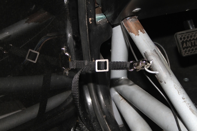 Here's our door strap kit completed and installed. This strap, which holds the door o a tab welded to the chassis near the roll cage, will keep the door from opening too far while in the pits, the staging lanes, or elsewhere.
